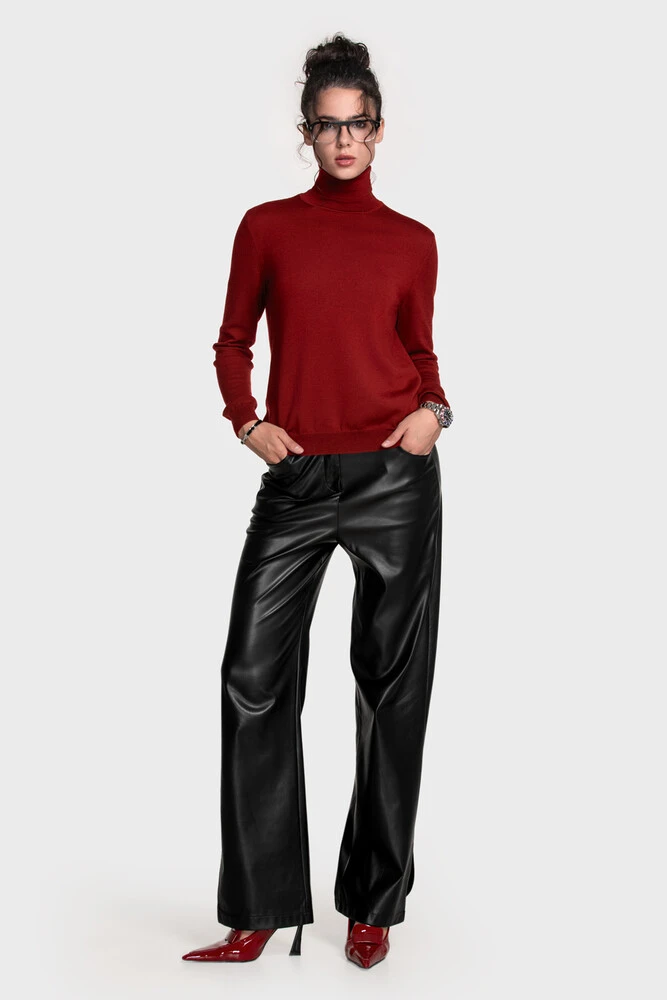 Deep red turtleneck with black leather-look wide trousers and red patent heels