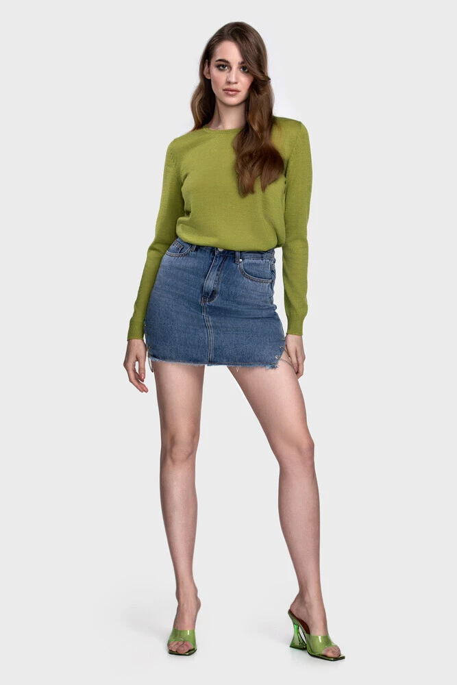 Apple green crewneck sweater with a raw-hem denim mini skirt and translucent heels